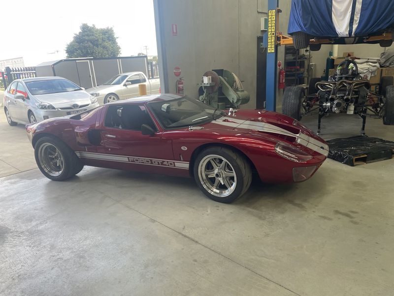 Maroon GT40 at the workshop bay