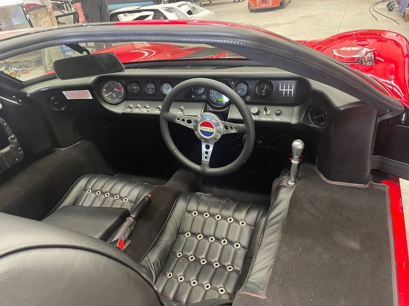 Cockpit interior with red dash and gauges